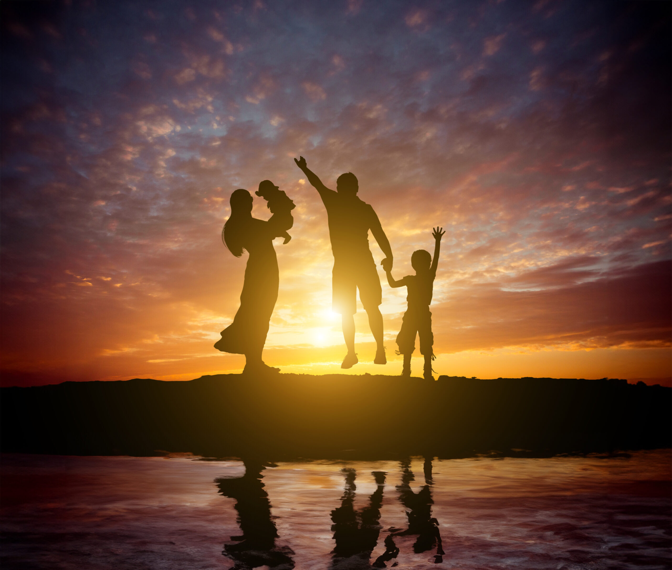 Family at sunset silhouettes